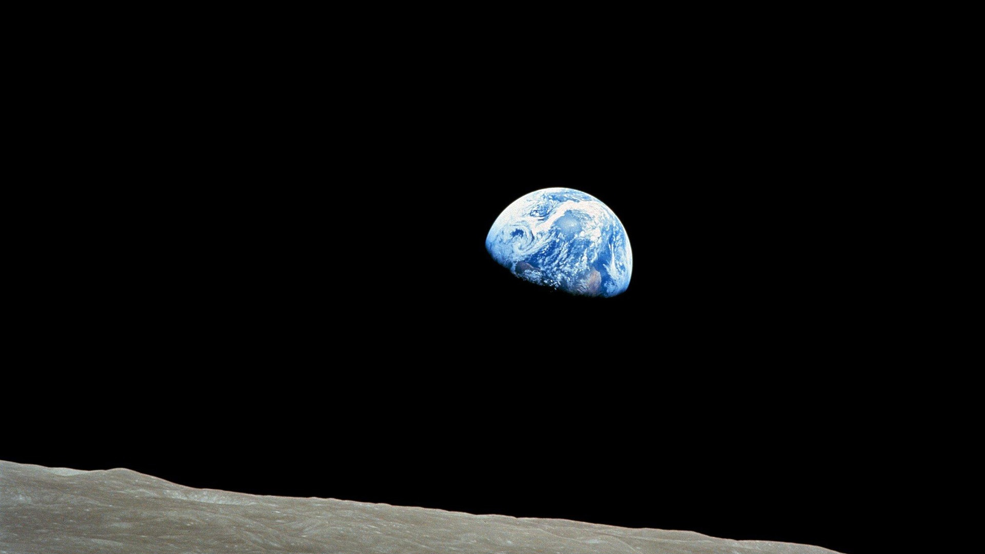 Earth rising above the Moon's horizon